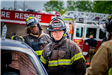 Firefighters standing near car for a drill