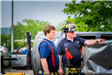 Firefighter and Lieutenant standing observing drills