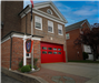 Fire station with red garage door and sign 