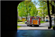 Fire truck driving down driveway away from fire station