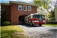 Fire truck driving away from fire station garage